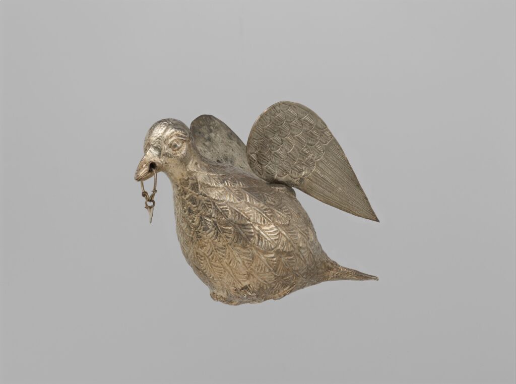 Silver dove figurine symbolizing peace, faith, and the Holy Spirit in Christian tradition