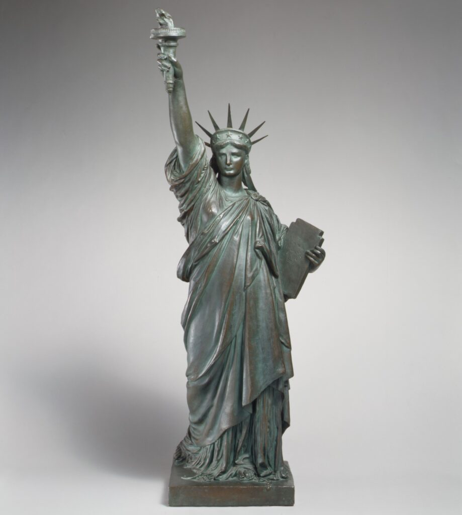 Statue of Liberty holding a torch and tablet, symbolizing freedom and independence.